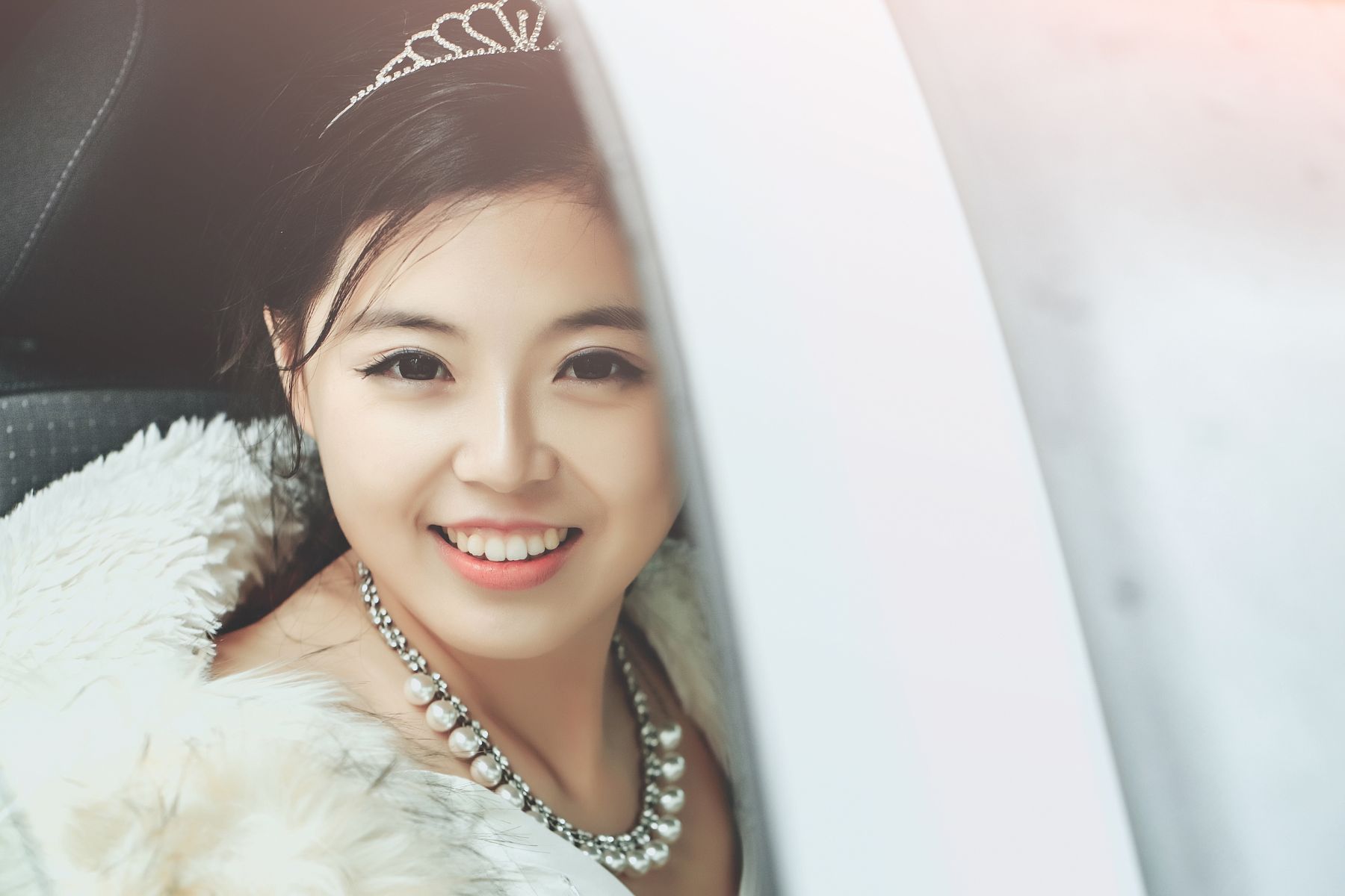 Pretty girl chinese smiling happy bride young asian woman smiles through car window
