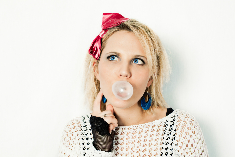 1980s girl blowing bubble gum.
